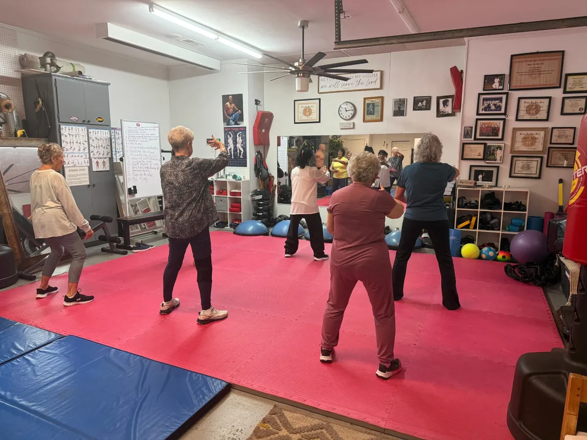 Older adults practicing gentle Tai Chi Qi Gong together in Heath, shown on the McLendon-Chisholm page